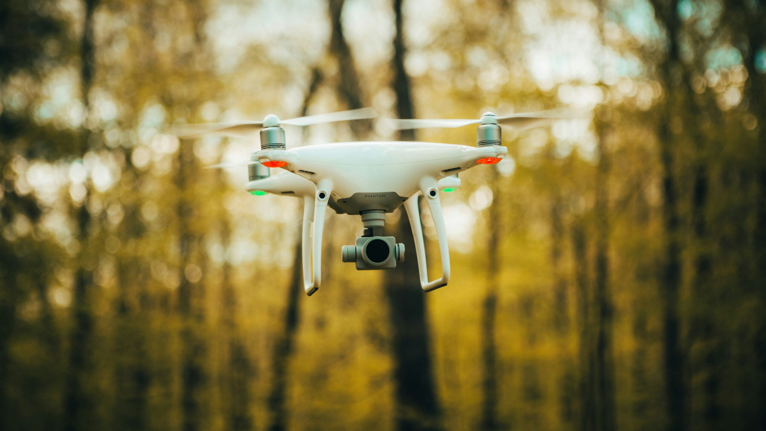 white drone flying during daytime